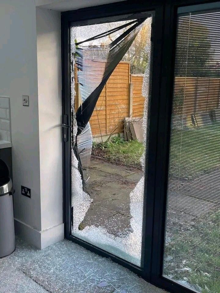 Broken patio glass door with shattered safety glazing everywhere